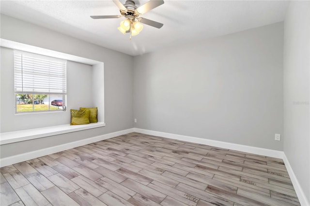 spare room with light hardwood / wood-style flooring and ceiling fan