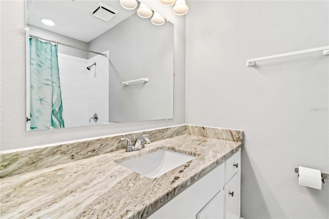 bathroom with vanity and curtained shower