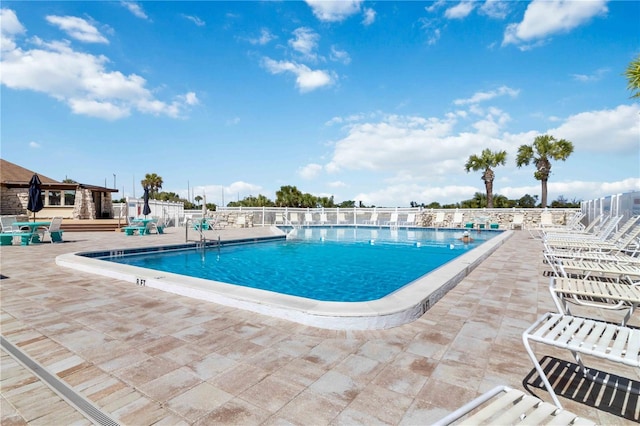 view of swimming pool with a patio area