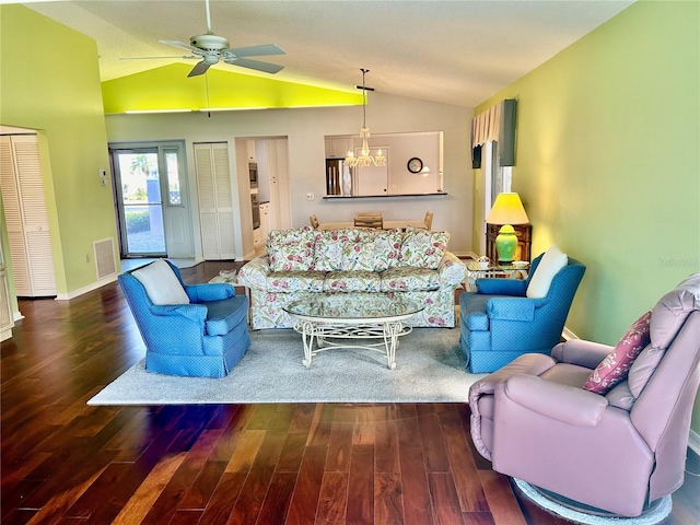 living room with vaulted ceiling, dark hardwood / wood-style floors, and ceiling fan with notable chandelier