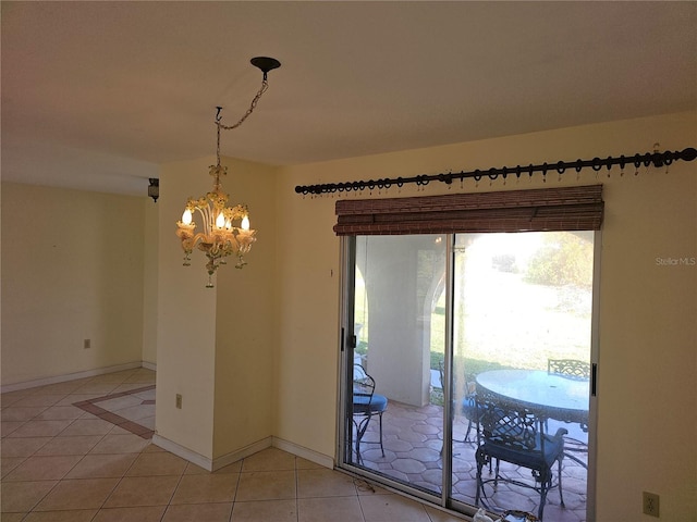 dining room featuring a chandelier and light tile patterned floors