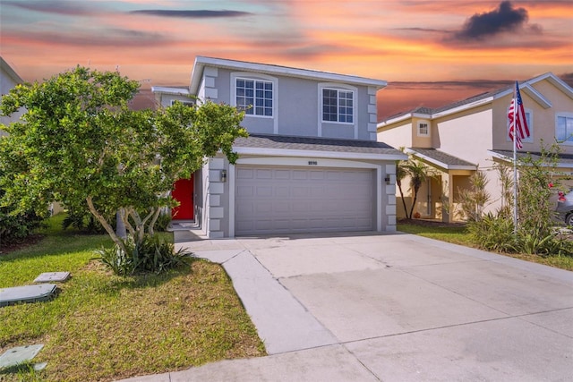 front facade featuring a yard and a garage