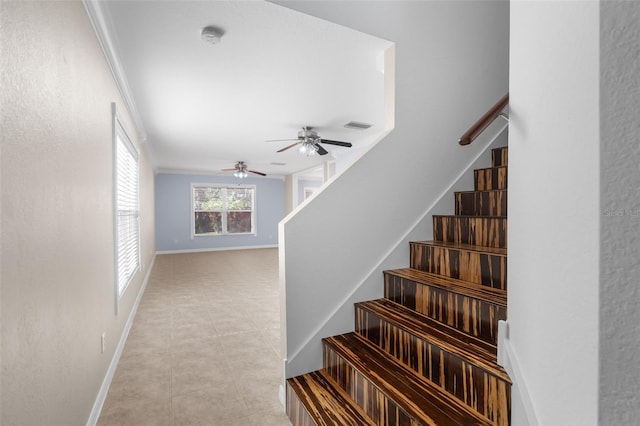 staircase featuring crown molding