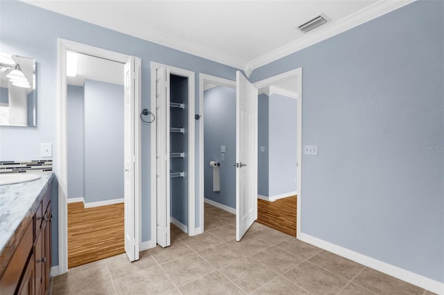 bathroom featuring vanity, hardwood / wood-style floors, and crown molding