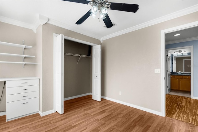 unfurnished bedroom with ceiling fan, ornamental molding, light hardwood / wood-style floors, a closet, and sink