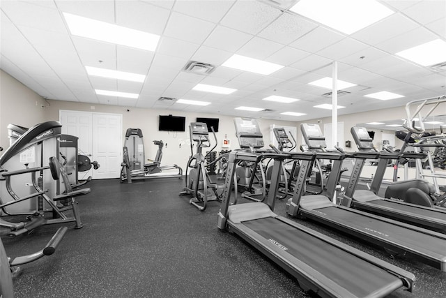 exercise room with a paneled ceiling