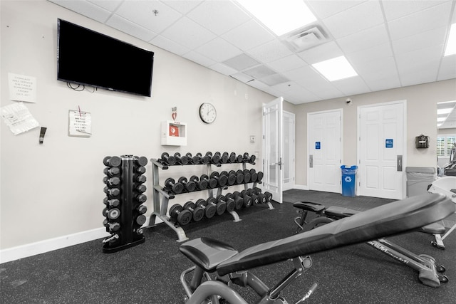 exercise room with a drop ceiling