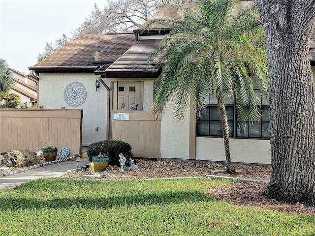 view of side of home featuring a lawn