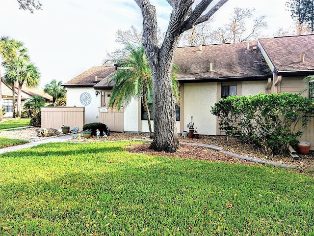 5650 Mashie Cir, North Port, FL 34287 - view of front of home with stucco siding, a front lawn, and a shingled roof