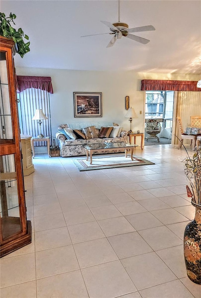 living room featuring light tile patterned floors and ceiling fan