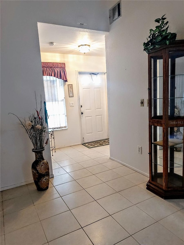 entrance foyer with light tile patterned floors