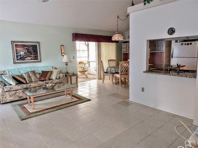 5650 Mashie Cir, North Port, FL 34287 - living area with tile patterned flooring and a chandelier