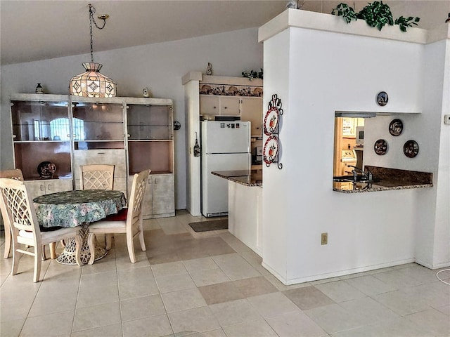 5650 Mashie Cir, North Port, FL 34287 - kitchen featuring freestanding refrigerator and light tile patterned floors