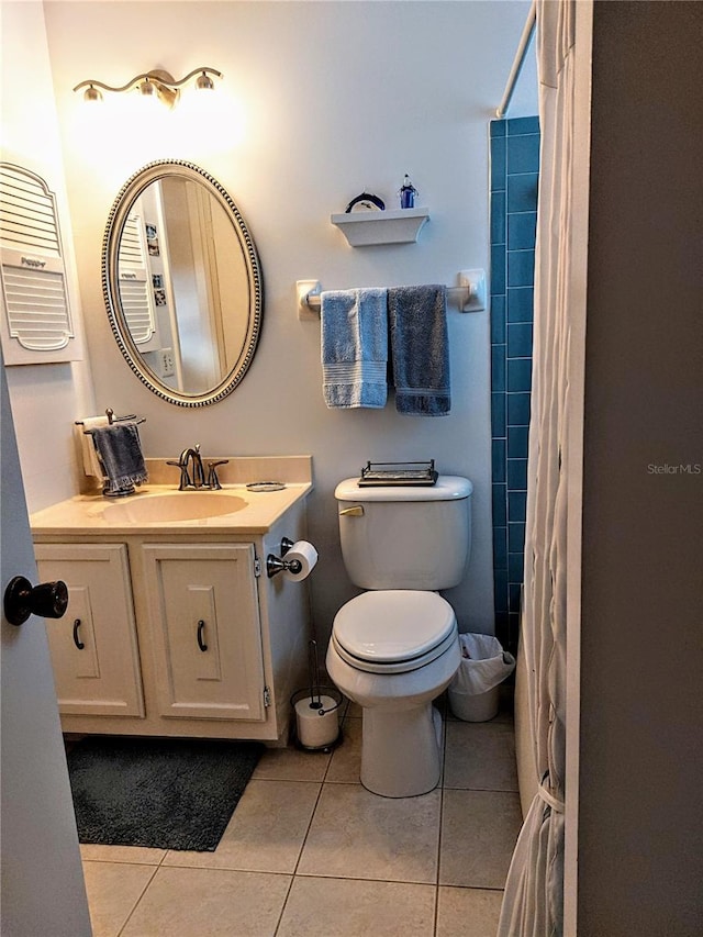 bathroom with tile patterned flooring, vanity, toilet, and a shower with curtain