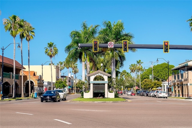 5650 Mashie Cir, North Port, FL 34287 - view of asphalt road featuring street lights, curbs, traffic lights, and sidewalks