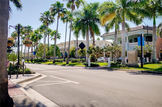 5650 Mashie Cir, North Port, FL 34287 - view of asphalt road featuring curbs, street lighting, sidewalks, and traffic signs