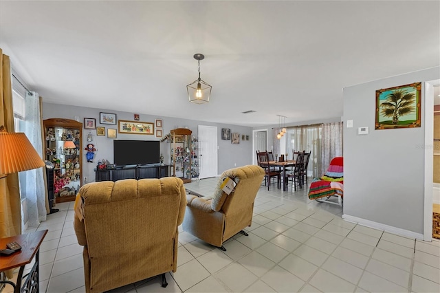 living room with a healthy amount of sunlight and light tile patterned floors