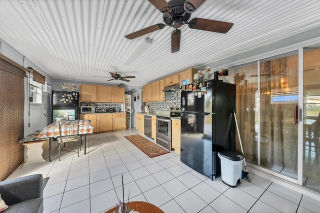 kitchen featuring stainless steel appliances, decorative backsplash, light tile patterned floors, and light brown cabinets