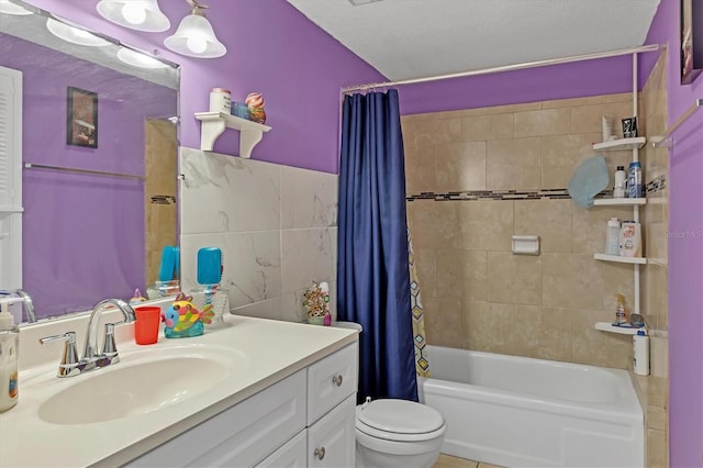 full bathroom with toilet, vanity, tile walls, a textured ceiling, and shower / bathtub combination with curtain