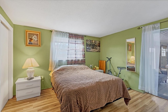 bedroom featuring a textured ceiling and light wood-type flooring