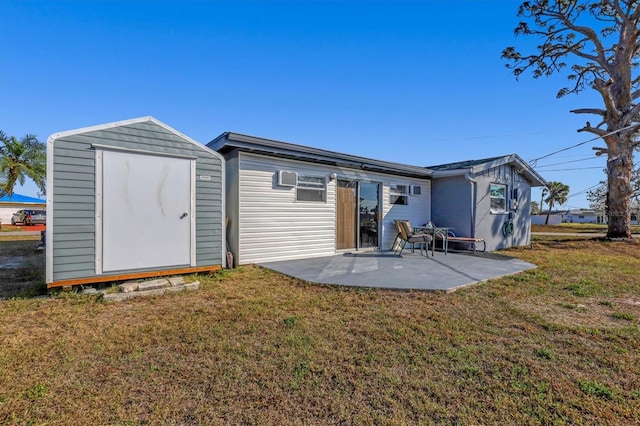 rear view of house with a patio, a storage shed, and a lawn