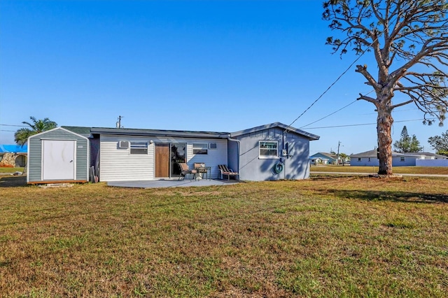 back of property featuring a patio, a shed, and a lawn