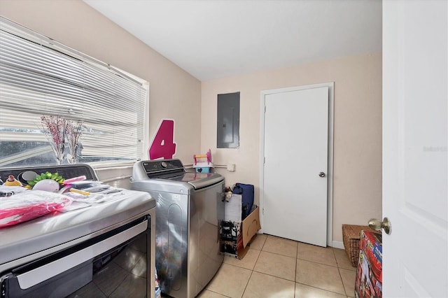 laundry room with light tile patterned flooring, electric panel, and separate washer and dryer