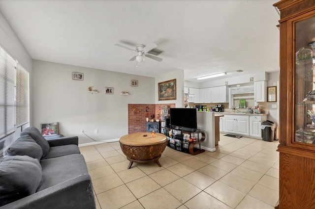 tiled living room with ceiling fan