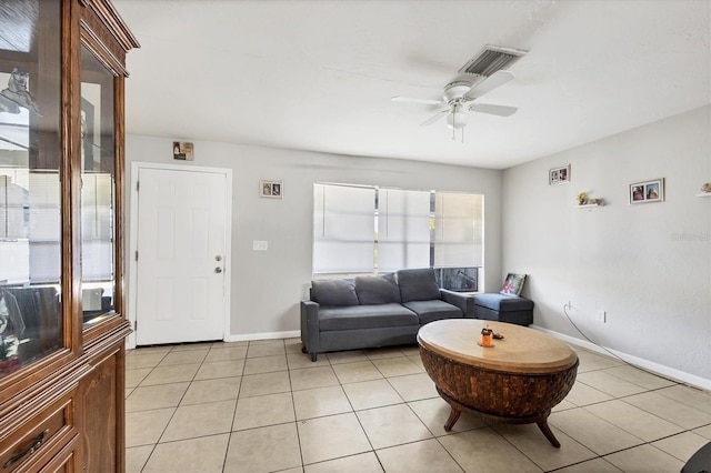 tiled living room with ceiling fan