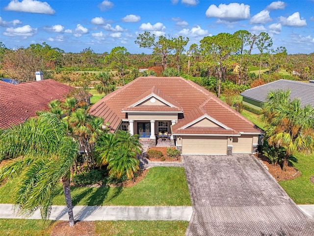 view of front of home with a front yard and a garage