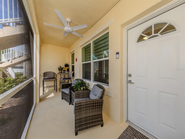 view of exterior entry featuring ceiling fan