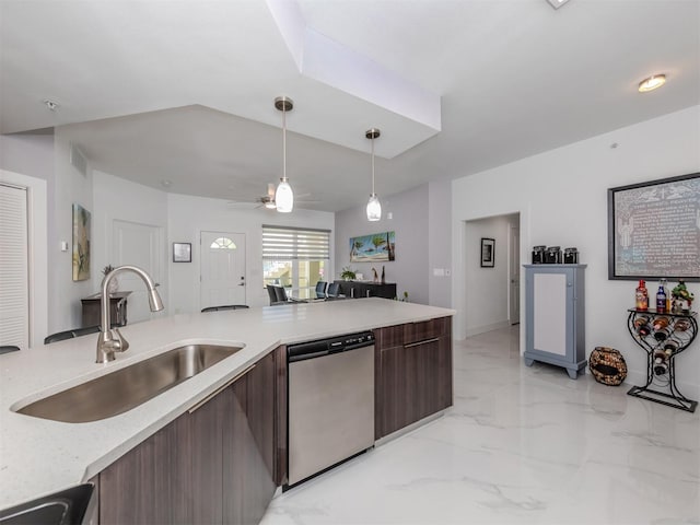 kitchen with stainless steel dishwasher, sink, dark brown cabinetry, and decorative light fixtures