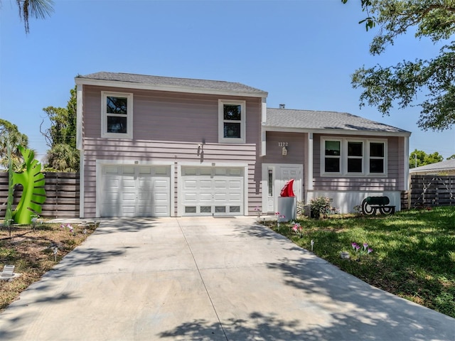 view of front of house featuring a front yard and a garage