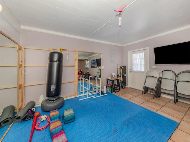 workout area featuring tile patterned floors and ornamental molding