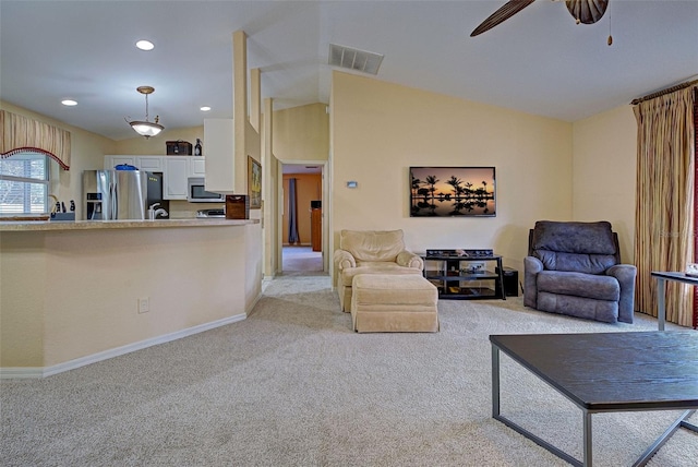 carpeted living room featuring ceiling fan and vaulted ceiling