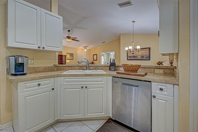 kitchen featuring white cabinetry, stainless steel dishwasher, vaulted ceiling, pendant lighting, and sink