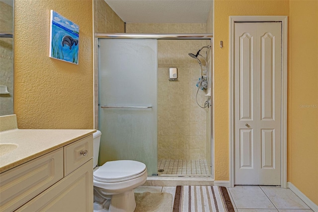 bathroom with vanity, toilet, tile patterned floors, and an enclosed shower