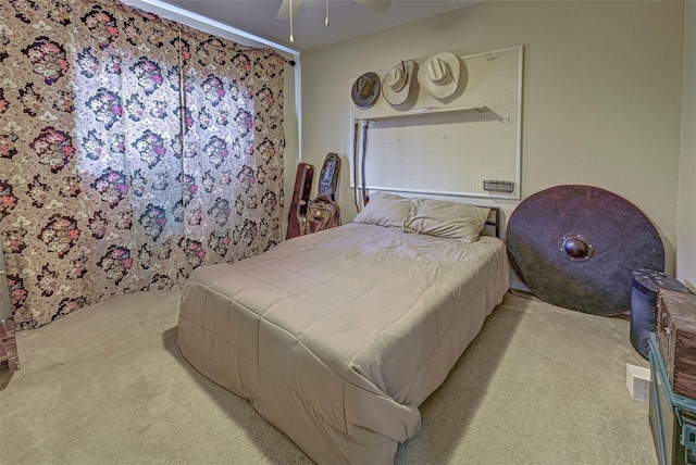 bedroom with ceiling fan and light colored carpet