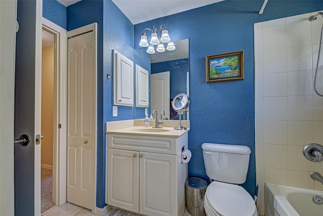 full bathroom with toilet, tiled shower / bath, vanity, and tile patterned flooring