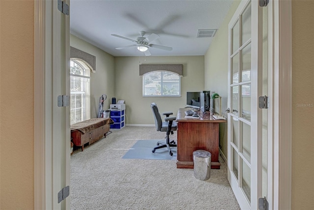 office space with light colored carpet and ceiling fan