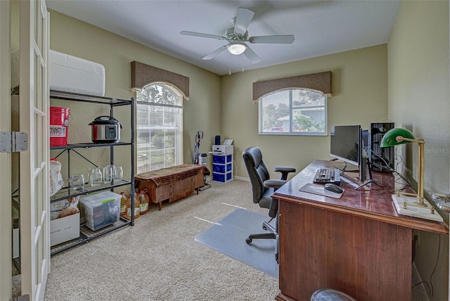 office space featuring light carpet, a healthy amount of sunlight, and ceiling fan