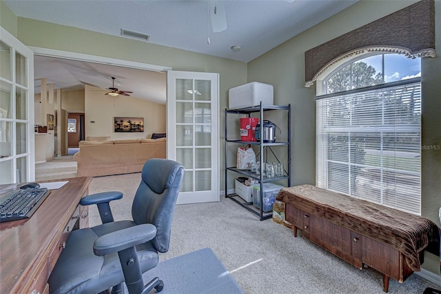 carpeted office space with french doors, vaulted ceiling, and ceiling fan