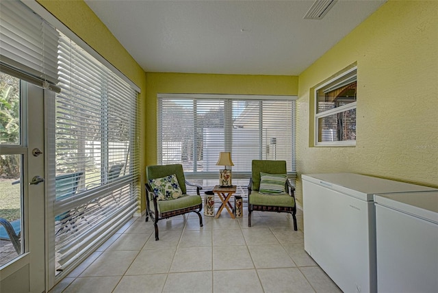 sunroom with washing machine and dryer