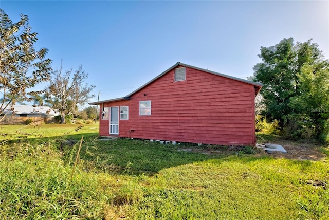 view of side of property with a lawn