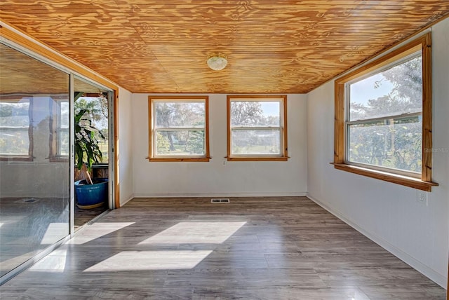 unfurnished sunroom featuring wooden ceiling