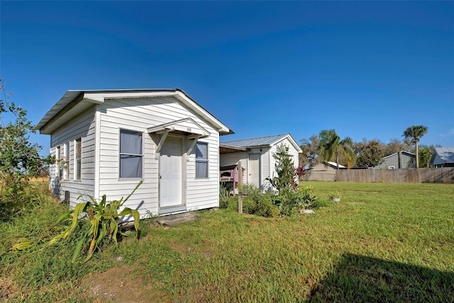 rear view of property featuring a yard