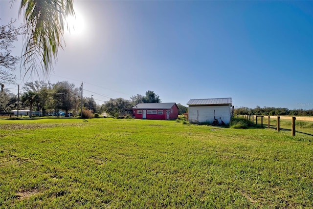 view of yard featuring a rural view and an outdoor structure