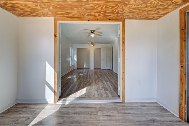 empty room featuring light hardwood / wood-style flooring, wooden ceiling, and ceiling fan