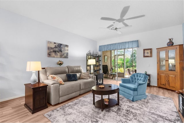 living room featuring light wood-type flooring and ceiling fan