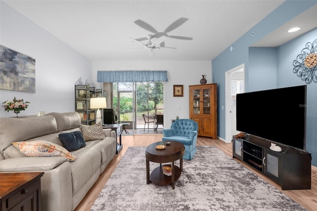 living room featuring light hardwood / wood-style flooring and ceiling fan